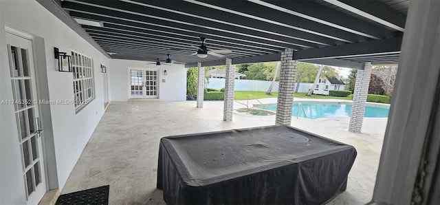 view of patio / terrace featuring french doors, ceiling fan, and a fenced in pool