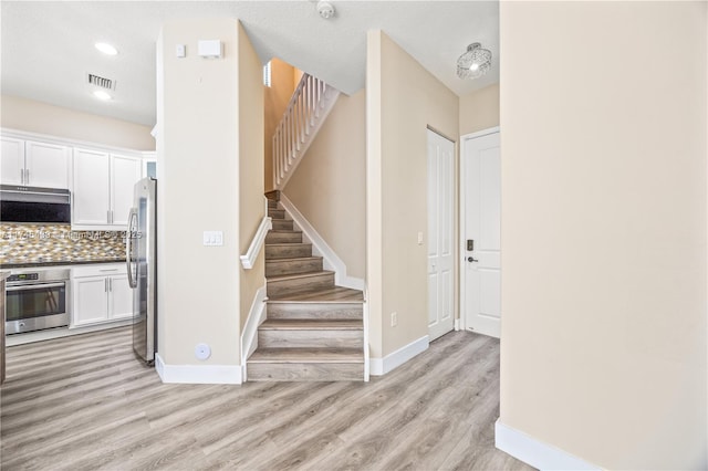 stairs with hardwood / wood-style flooring