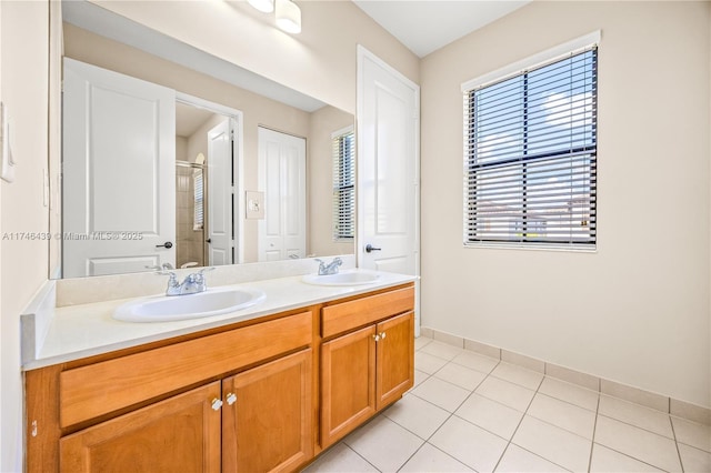 bathroom with tile patterned floors, vanity, and walk in shower