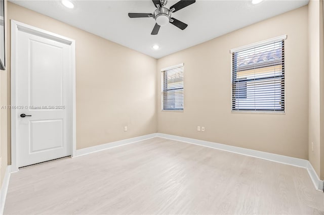 spare room with light wood-type flooring and ceiling fan