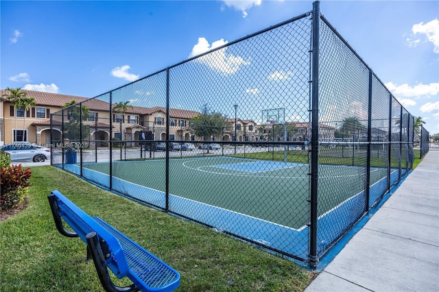 view of sport court featuring a yard