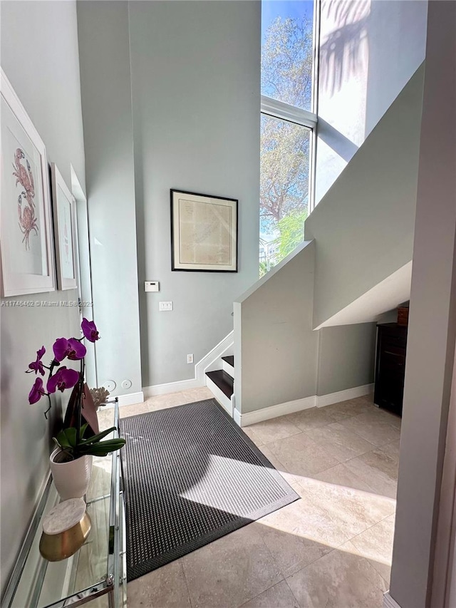 interior space with a towering ceiling and baseboards