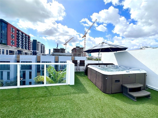 view of yard featuring central AC, a city view, and a hot tub