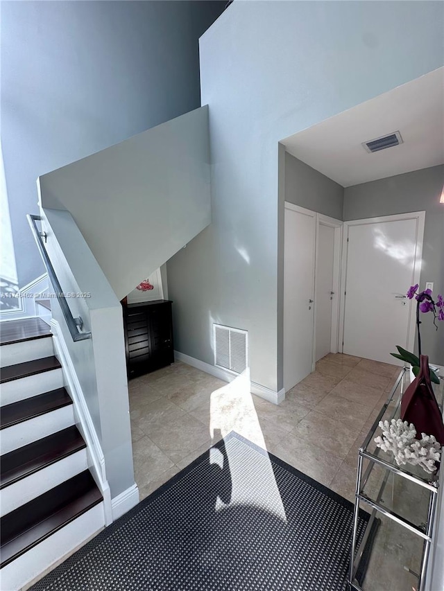 stairs featuring visible vents and baseboards