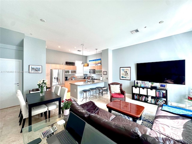 living area with light tile patterned floors and visible vents