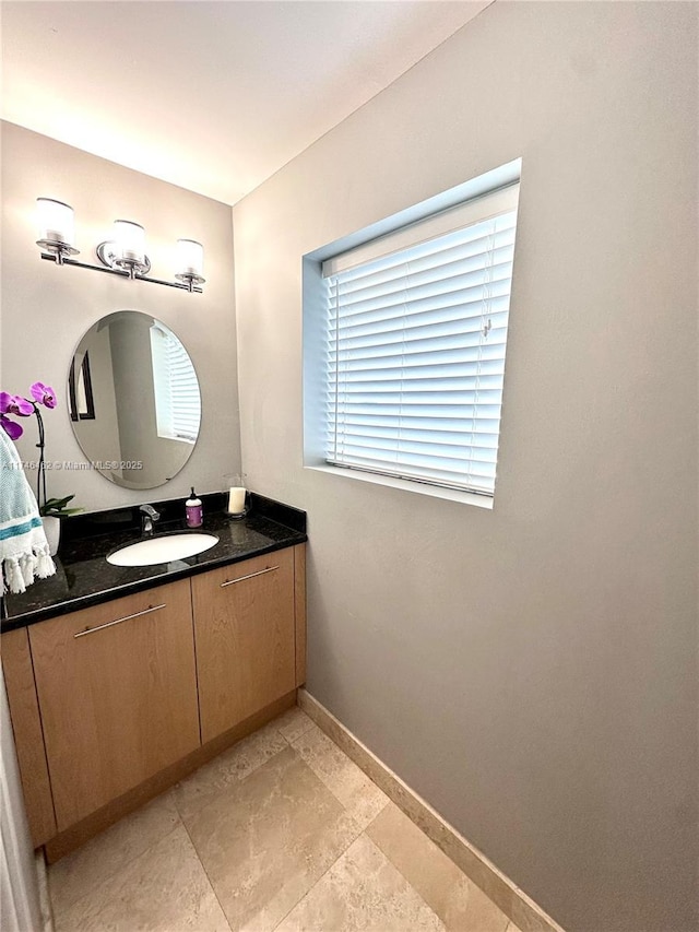 bathroom featuring baseboards and vanity