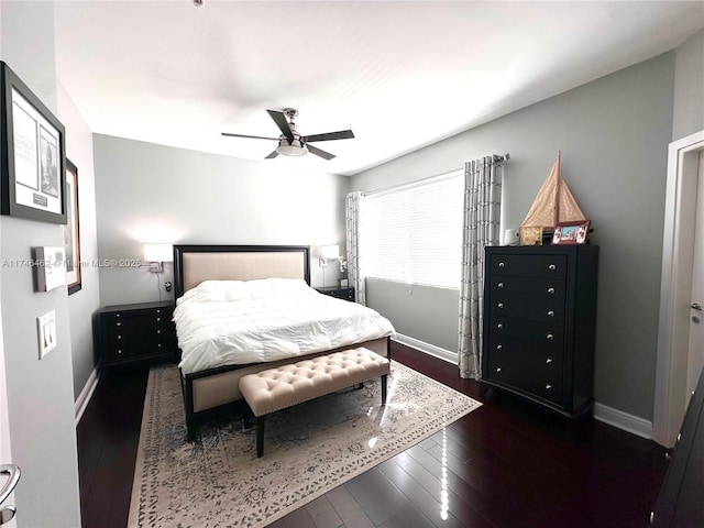 bedroom with dark wood-style floors, a ceiling fan, and baseboards