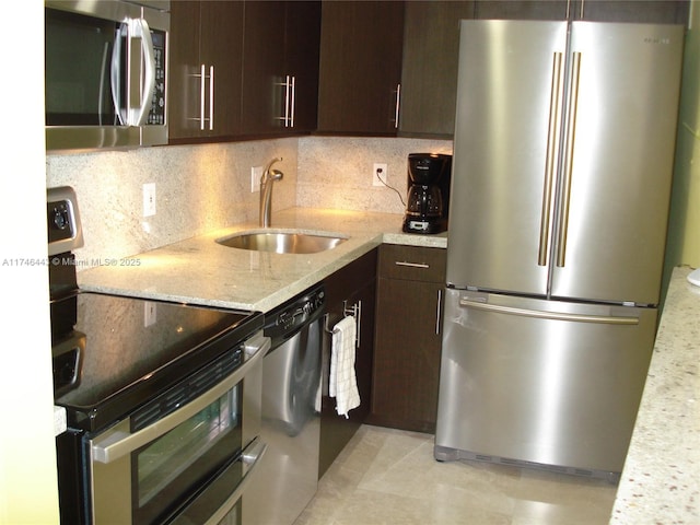 770 Claughton Island Dr Unit 1708, Miami, FL 33131 - kitchen with stainless steel appliances, dark brown cabinets, a sink, light stone countertops, and decorative backsplash
