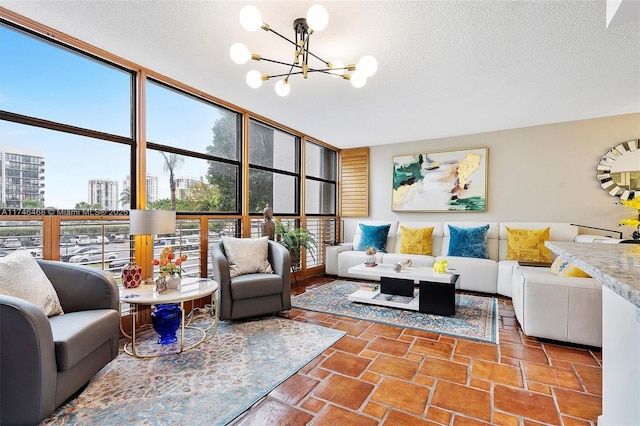 living room featuring a wall of windows, a notable chandelier, and a textured ceiling