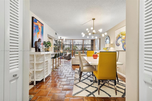 dining space featuring a textured ceiling and an inviting chandelier