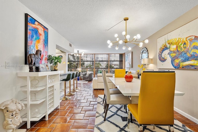 dining room with an inviting chandelier and a textured ceiling