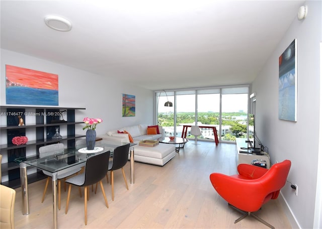 interior space featuring a wall of windows and light hardwood / wood-style flooring