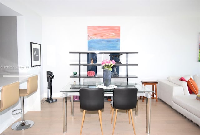 dining space with light hardwood / wood-style flooring