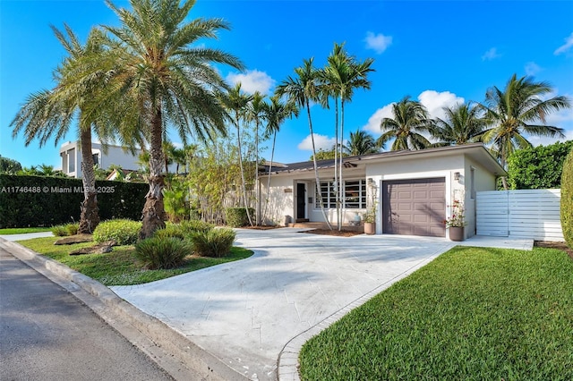 ranch-style home featuring a garage and a front yard