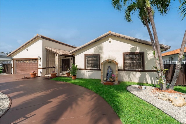 mediterranean / spanish-style home with a garage