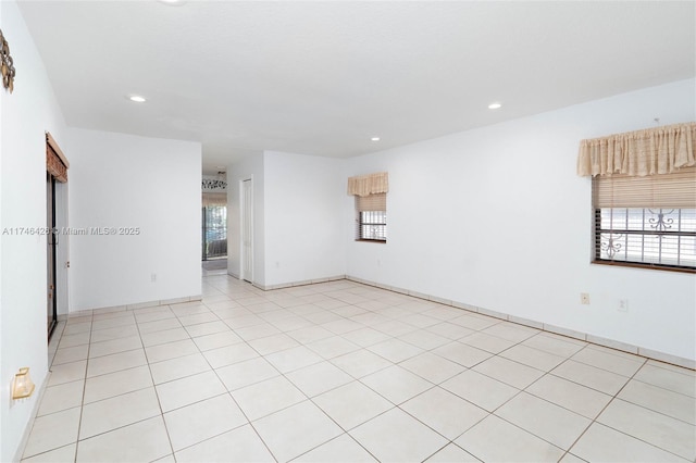 tiled spare room featuring a wealth of natural light