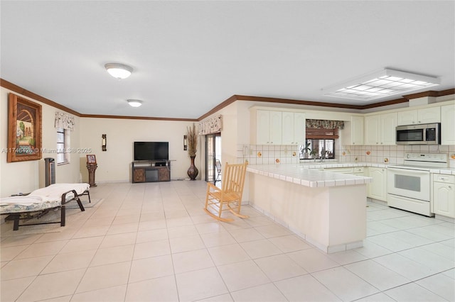 kitchen featuring light tile patterned floors, white range with electric cooktop, backsplash, ornamental molding, and tile countertops