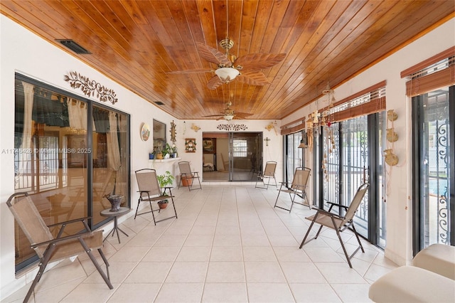 sunroom featuring ceiling fan and wood ceiling