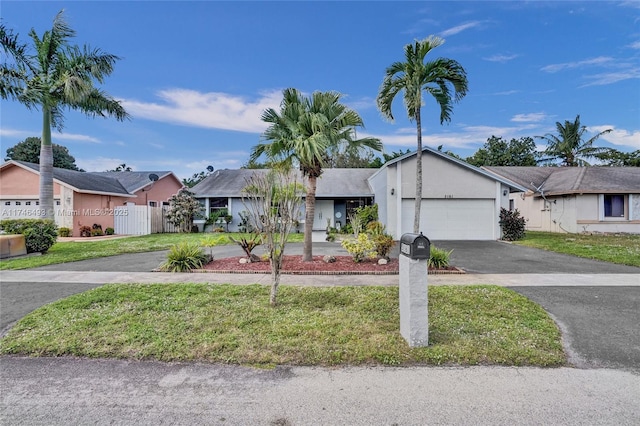 ranch-style home with a garage and a front yard