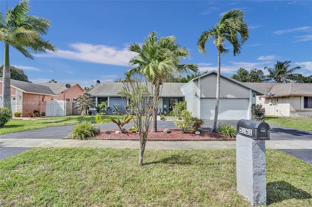 single story home featuring a garage and a front lawn