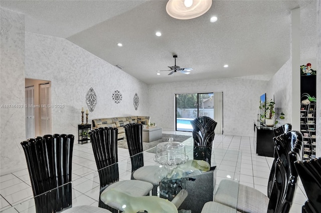 tiled dining area featuring ceiling fan, vaulted ceiling, and a textured ceiling