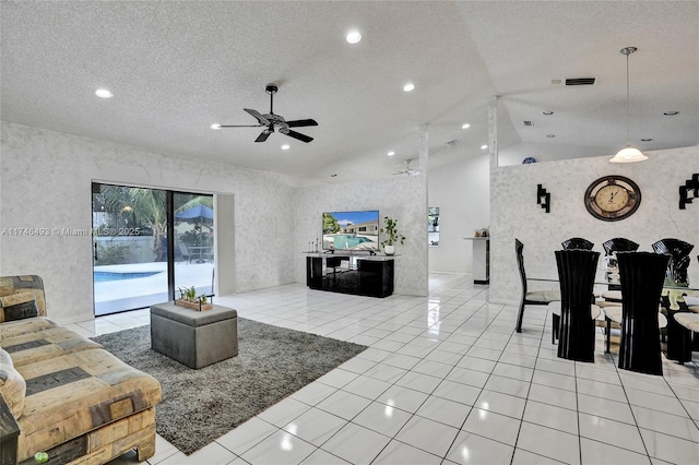 tiled living room with ceiling fan, lofted ceiling, and a textured ceiling