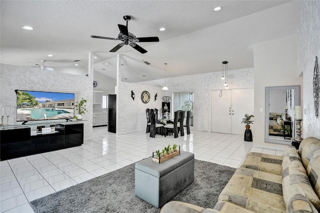 living room with light tile patterned floors, a textured ceiling, high vaulted ceiling, and ceiling fan