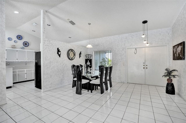 tiled dining area featuring lofted ceiling