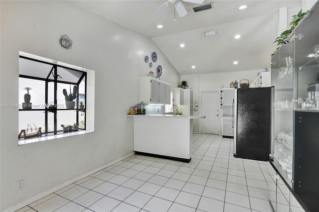 kitchen with white cabinetry, light tile patterned floors, stainless steel refrigerator, kitchen peninsula, and ceiling fan