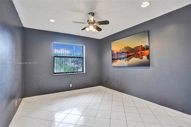 empty room with a textured ceiling and ceiling fan