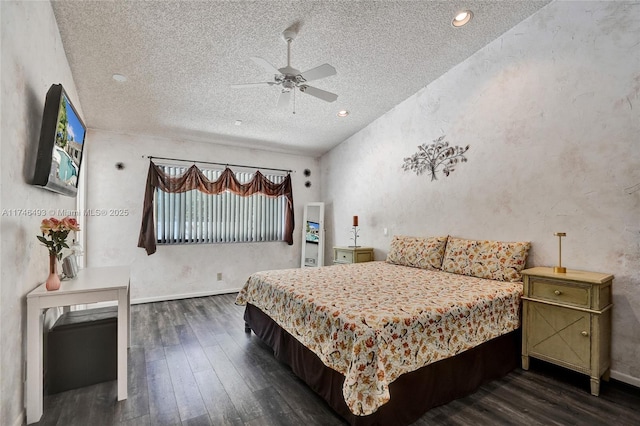 bedroom with ceiling fan, dark hardwood / wood-style floors, and a textured ceiling