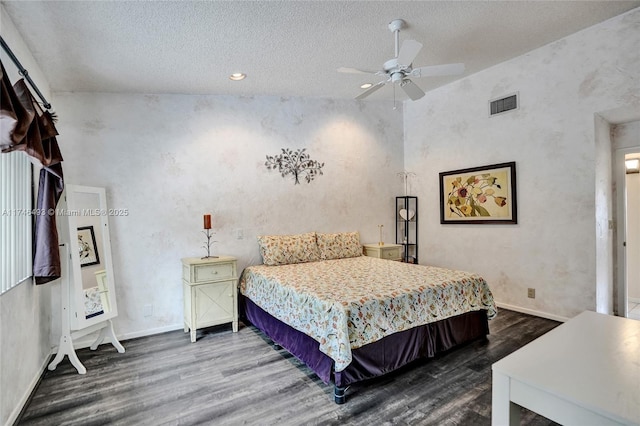 bedroom with ceiling fan, dark hardwood / wood-style floors, and a textured ceiling