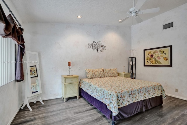 bedroom featuring hardwood / wood-style floors, a textured ceiling, and ceiling fan