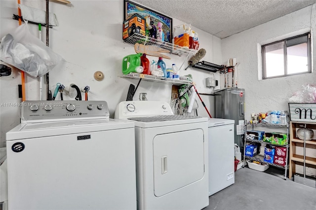 clothes washing area featuring electric water heater, washer and dryer, and a textured ceiling