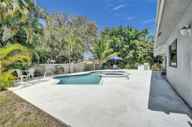 view of swimming pool with an in ground hot tub and a patio