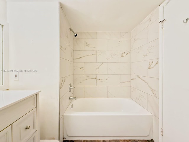 bathroom featuring vanity and tiled shower / bath