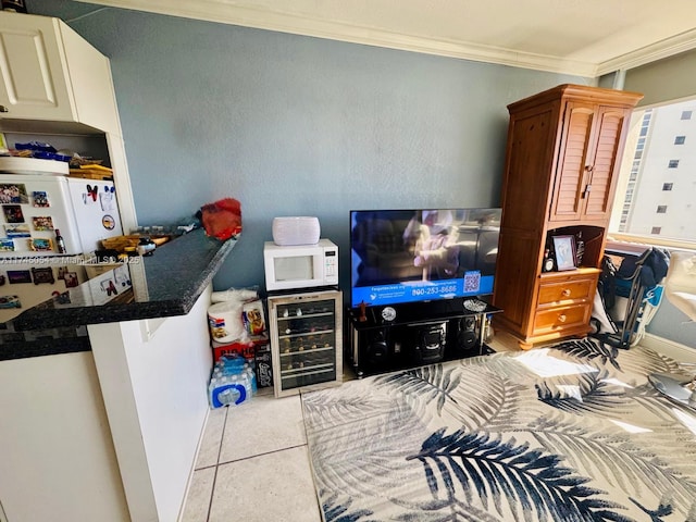 bedroom with wine cooler, white refrigerator, crown molding, and light tile patterned floors