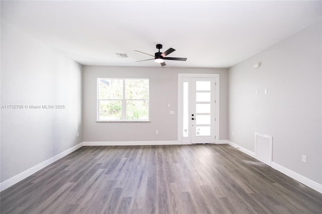 unfurnished room featuring dark wood-type flooring and ceiling fan