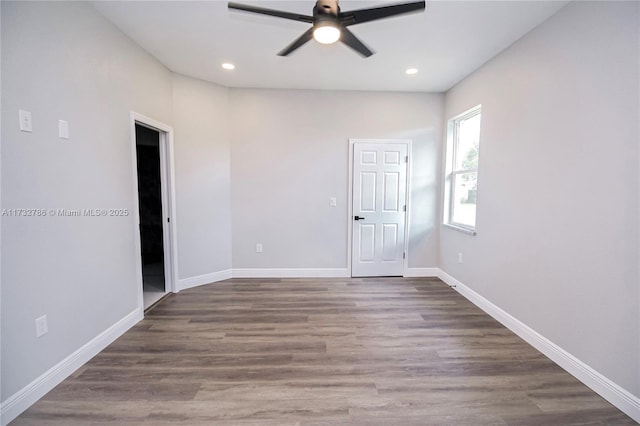 spare room with dark hardwood / wood-style floors and ceiling fan