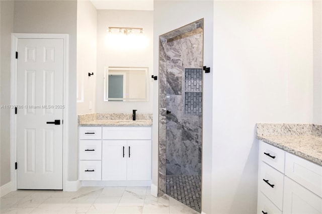 bathroom with vanity and tiled shower