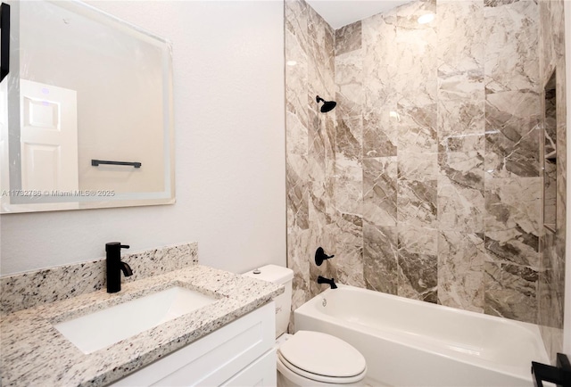 full bathroom with vanity, toilet, and tiled shower / bath combo