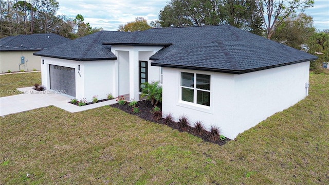 view of front of home with a garage and a front lawn