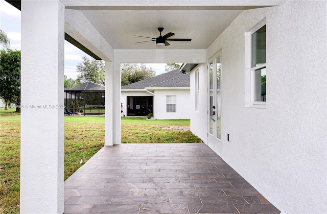 view of patio / terrace featuring ceiling fan and a lanai