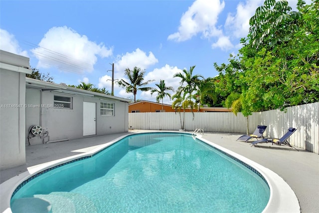 view of swimming pool with a patio, a fenced backyard, and a fenced in pool