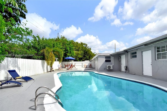 view of swimming pool with a fenced in pool, a fenced backyard, and a patio