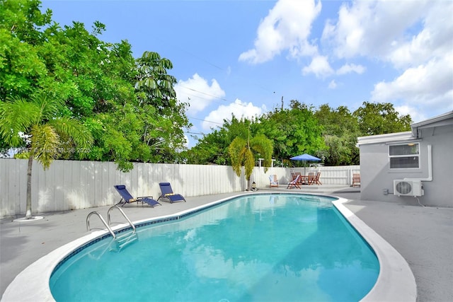 view of pool with a patio, ac unit, a fenced backyard, and a fenced in pool