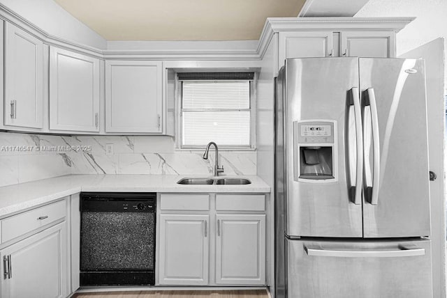 kitchen featuring a sink, light countertops, backsplash, stainless steel fridge with ice dispenser, and dishwasher