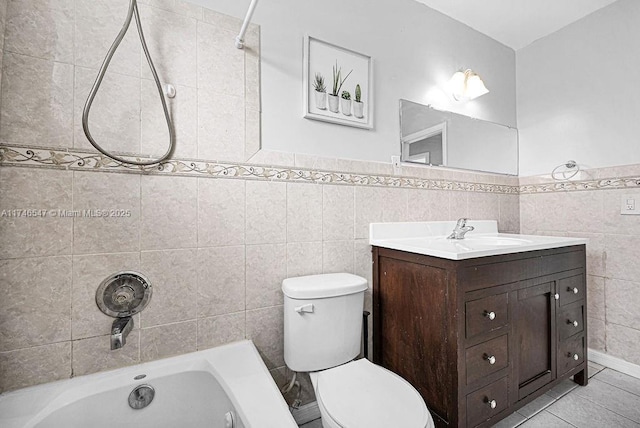 full bath featuring toilet, bathing tub / shower combination, vanity, tile walls, and tile patterned floors