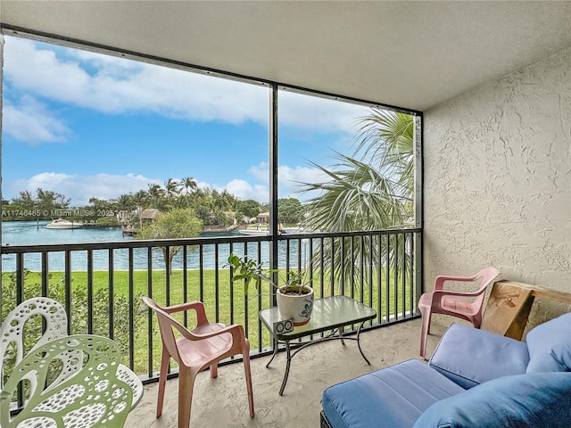 sunroom / solarium featuring a water view