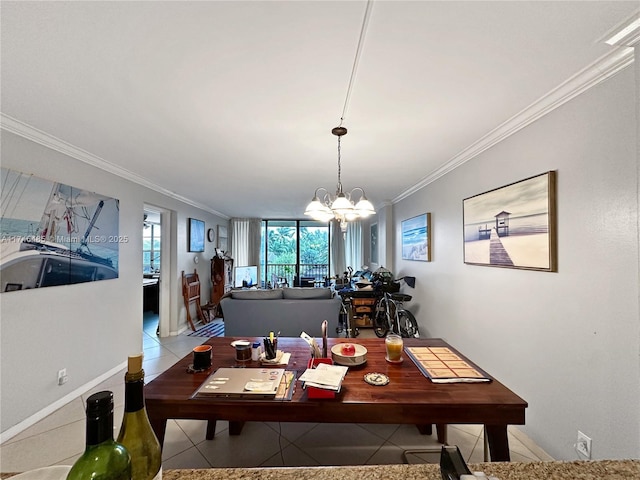 dining area featuring a chandelier, ornamental molding, tile patterned flooring, and baseboards